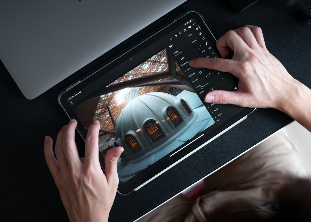 gallery-1 Hands editing architectural photo on tablet using Lightroom app.